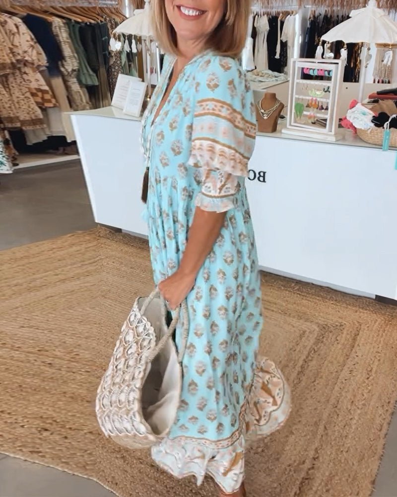 Side profile of a women's chic floral V-neck maxi dress, highlighting its flowing design.