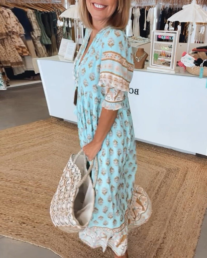 Side profile of a women's chic floral V-neck maxi dress, highlighting its flowing design.