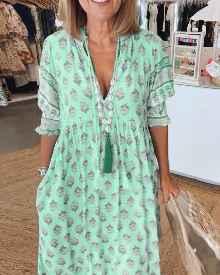 Woman wearing a chic floral V-neck maxi dress, showcasing elegant everyday style.