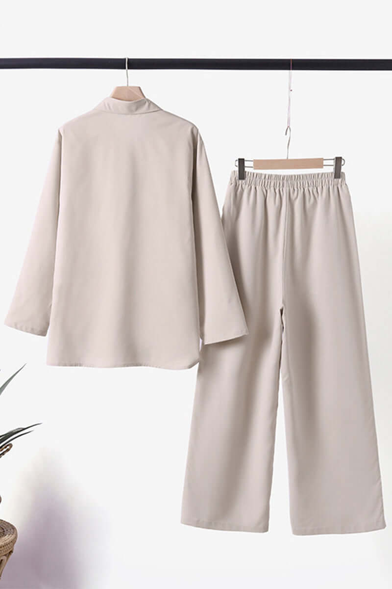 Chic women's two-piece set: fold-over collar long sleeve top & matching trousers for a coordinated look.