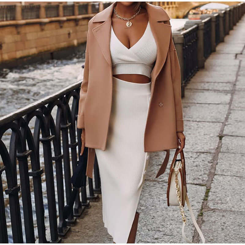Women's spring/summer knitted set: a versatile V-neck top and midi skirt ensemble for effortless elegance.