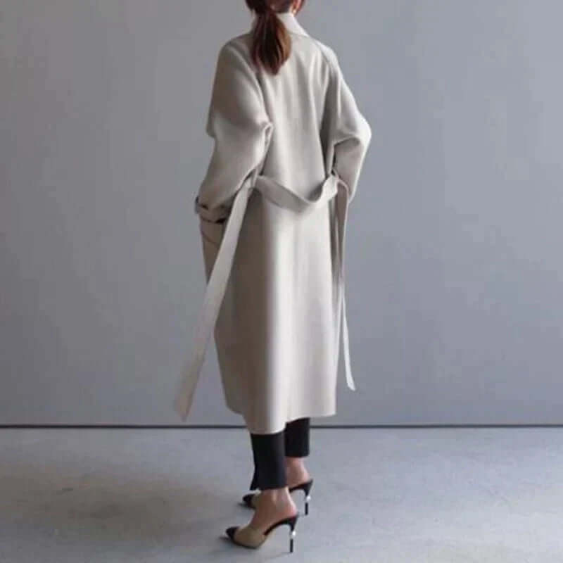 Modern women's oversized winter coat with a sleek belt, offering warmth and a chic fashion look.
