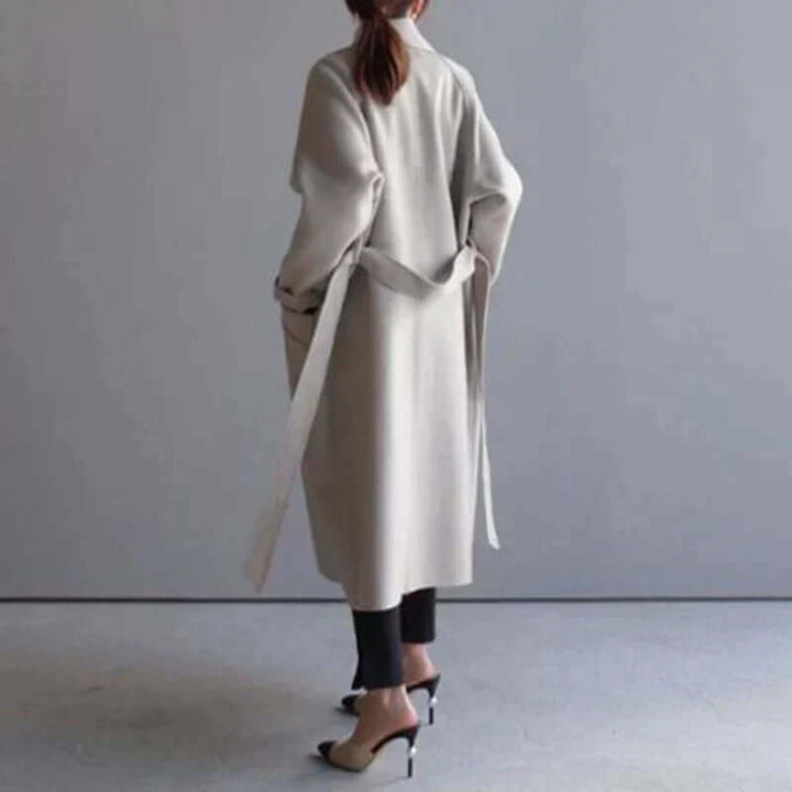 Modern women's oversized winter coat with a sleek belt, offering warmth and a chic fashion look.
