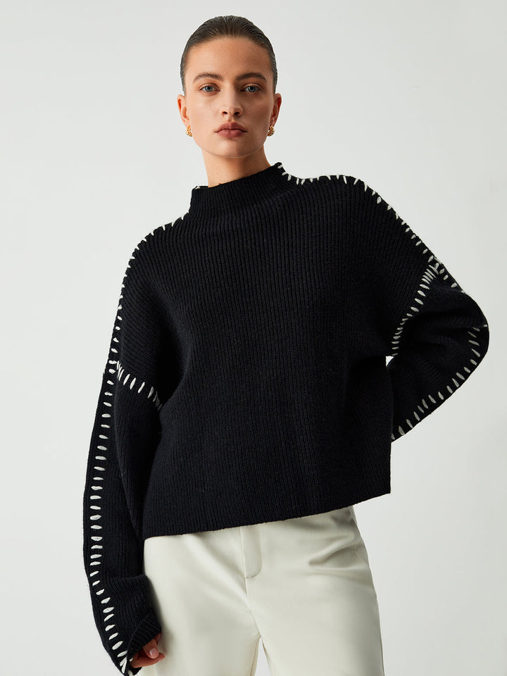 Stylish black oversized sweater with mock neck. Ideal for casual fashion and comfortable everyday wear.