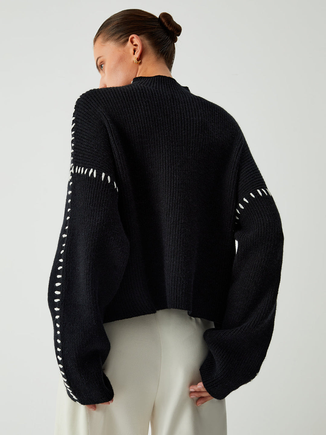 Comfortable women's oversized mock neck sweater in black, featuring a relaxed fit for ultimate comfort.