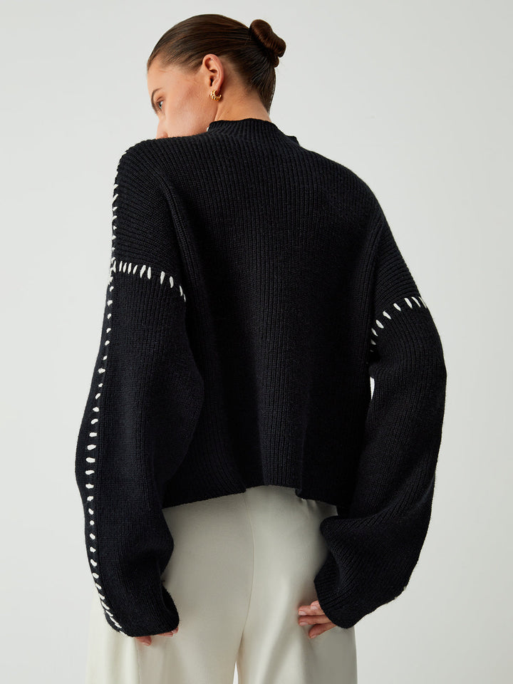 Comfortable women's oversized mock neck sweater in black, featuring a relaxed fit for ultimate comfort.