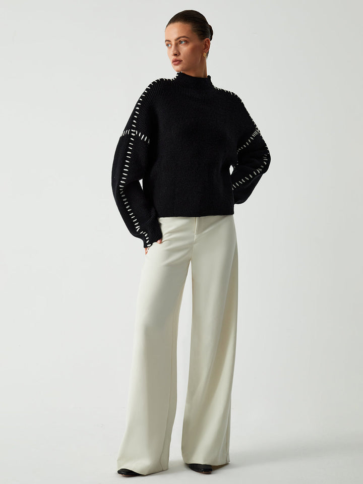 Fashionable black oversized mock neck sweater, a stylish top for women's fall outfits and winter layering.