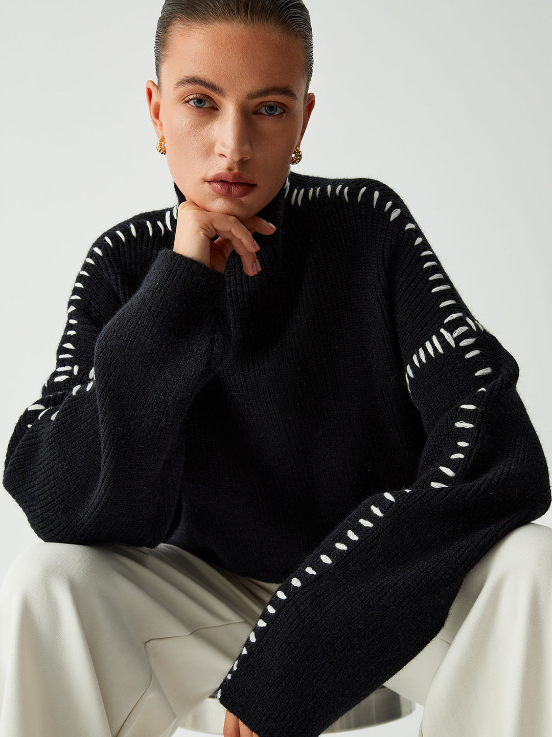 Elegant women's oversized black sweater with a mock neck, offering a stylish and comfortable relaxed fit.