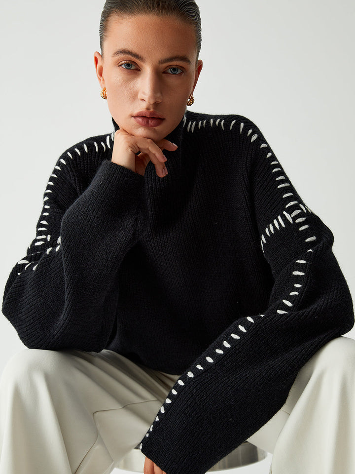 Elegant women's oversized black sweater with a mock neck, offering a stylish and comfortable relaxed fit.