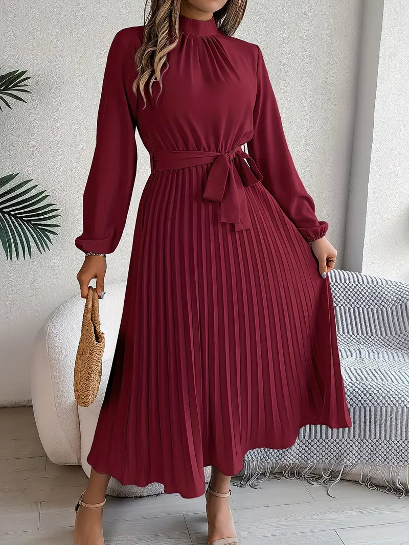 Wedding guest midi dress for women, featuring a pleated skirt, long sleeves, high neck & stylish belt.