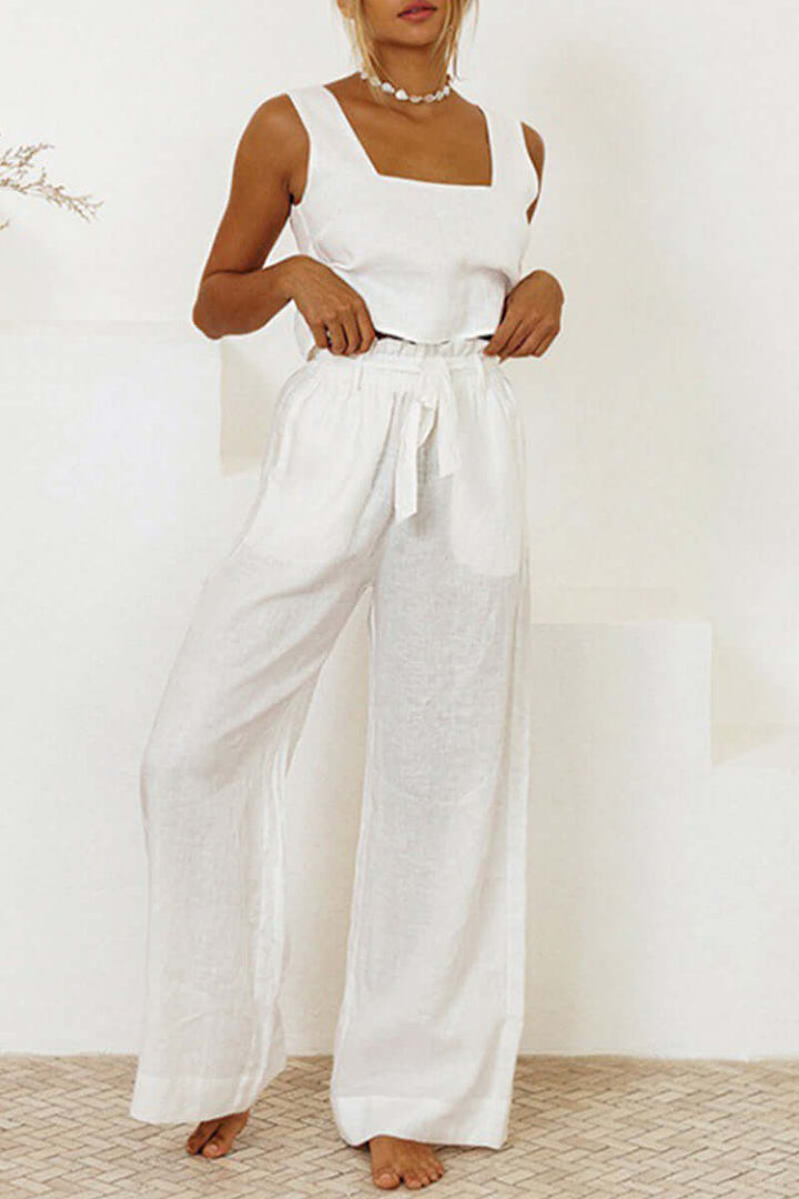 Stylish women's two-piece set featuring a sleeveless crop top and comfortable wide leg pants, available in white.
