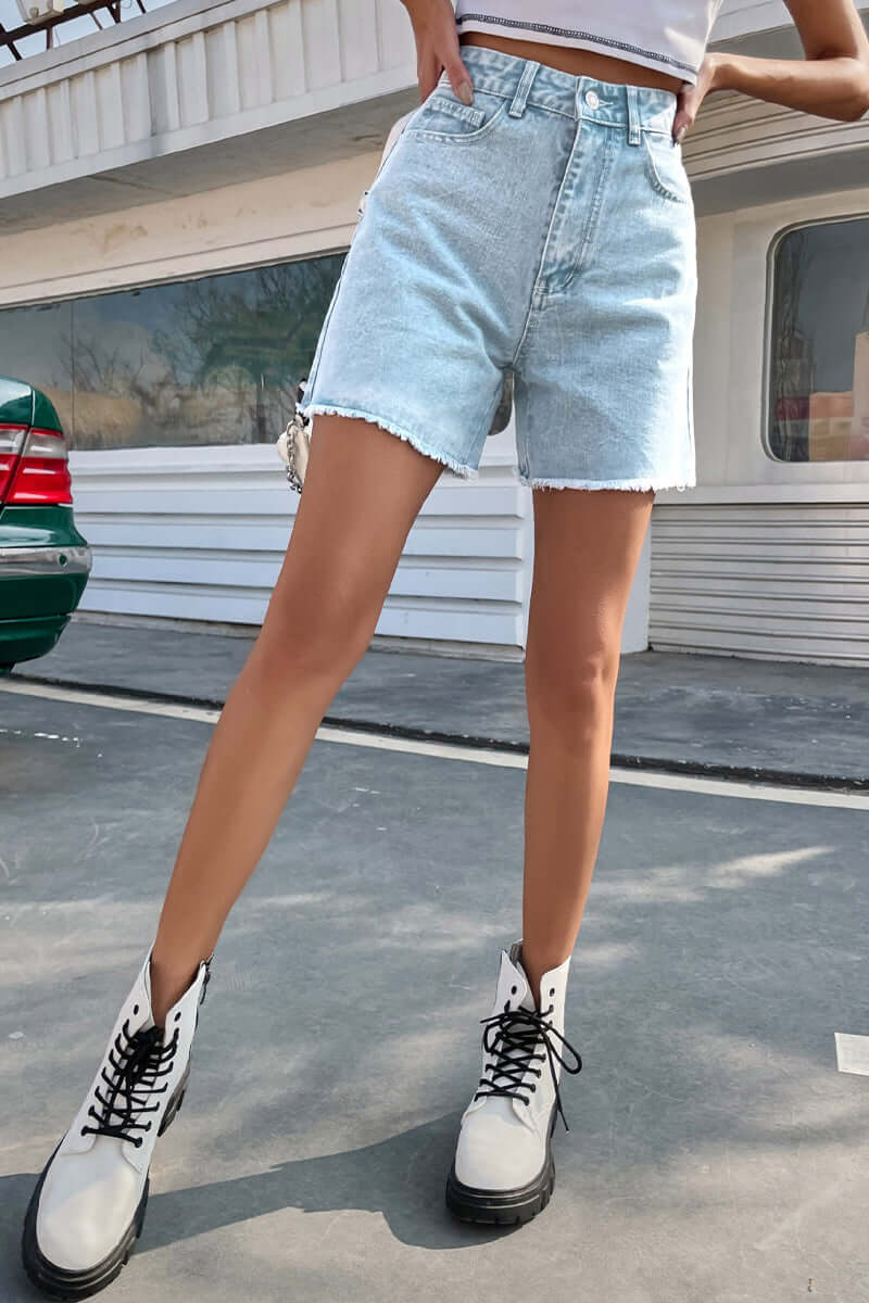 Flattering women's denim shorts with a raw hem, ideal for stylish and comfortable summer days.
