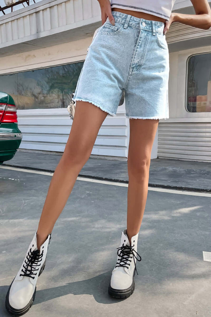 Flattering women's denim shorts with a raw hem, ideal for stylish and comfortable summer days.