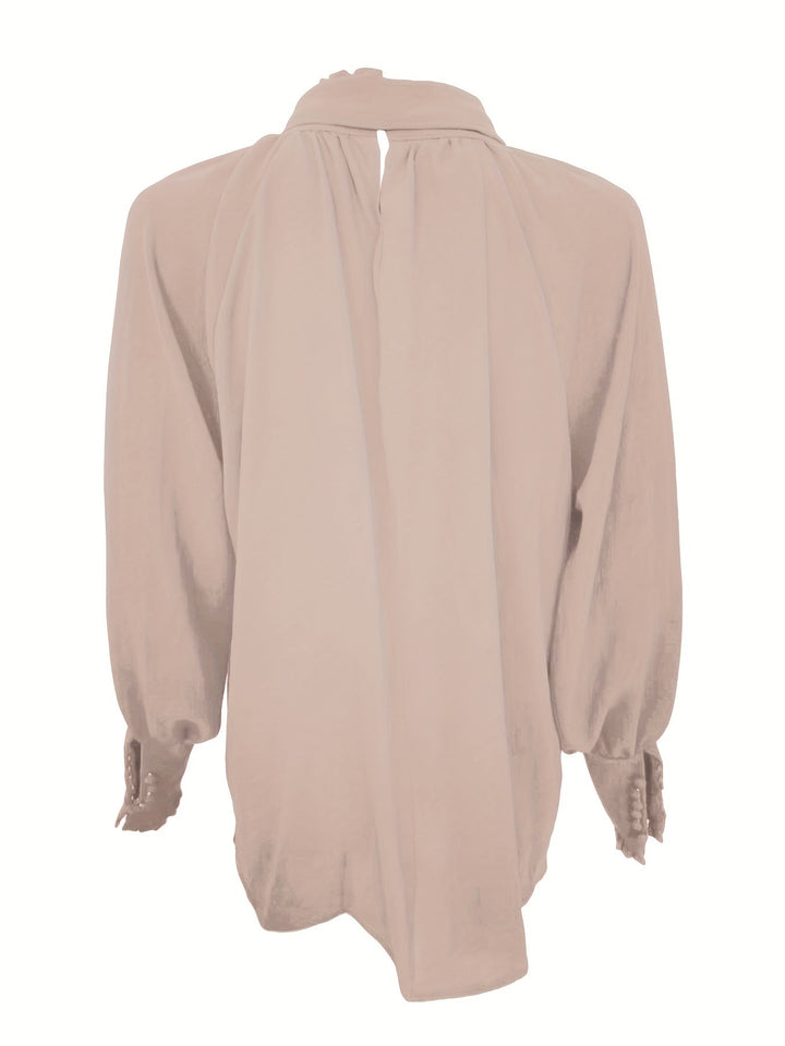 Flowing women's long sleeve blouse with an elegant tie neck and chic ruffle details.