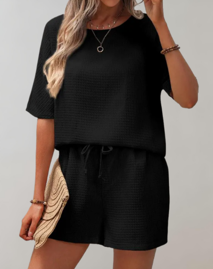 Women's chic two-piece outfit with stylish top & loose shorts, perfect for summer casual wear and vacation.