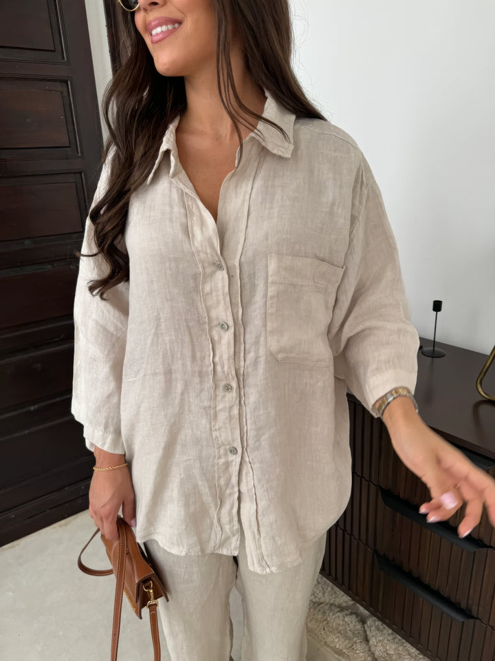 Elegant women's matching long-sleeve top and wide-leg pant set for a relaxed summer casual outfit.