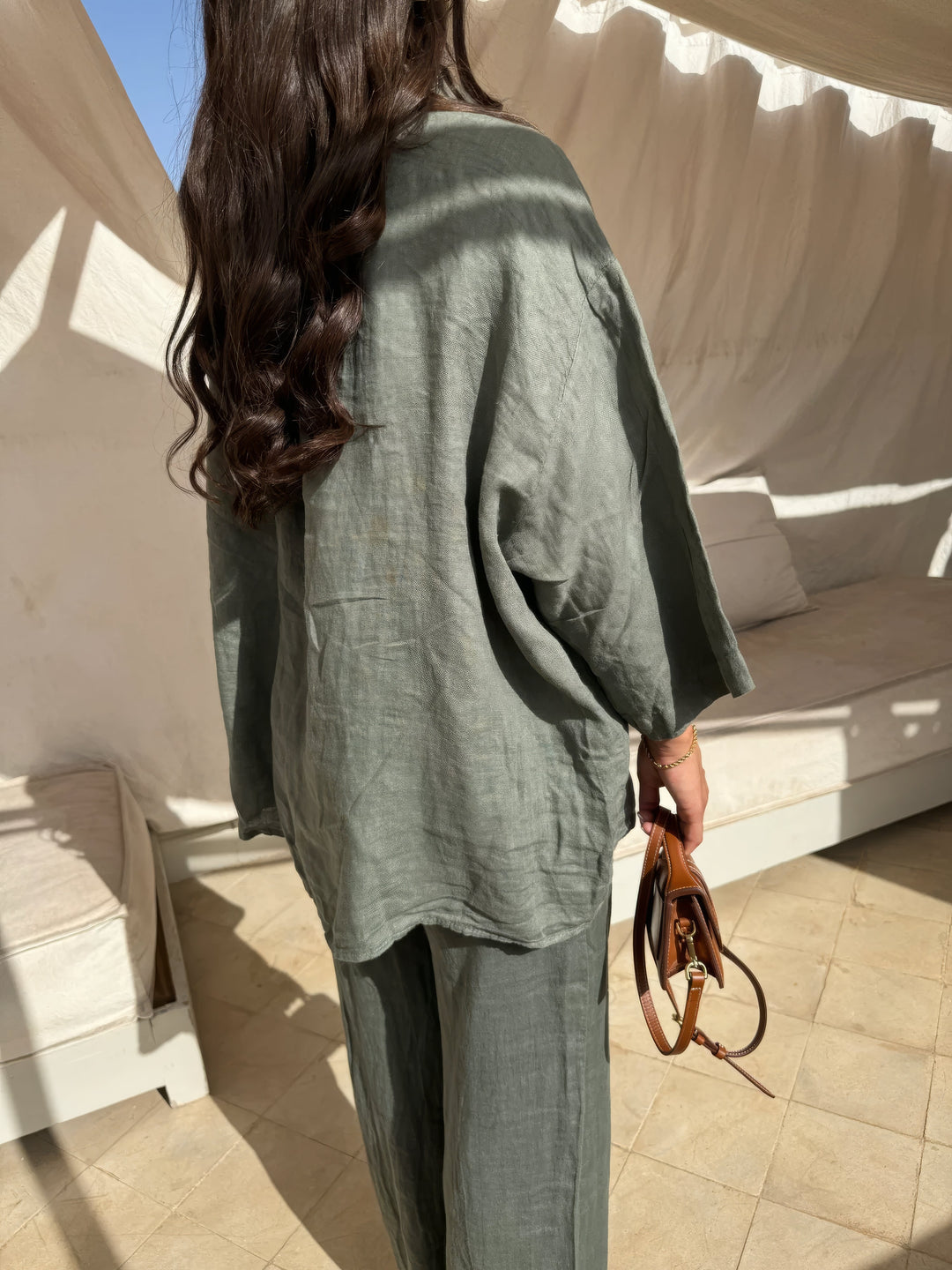 Relaxed elegant women's two-piece long-sleeve top and wide-leg pant set for summer casual wear.
