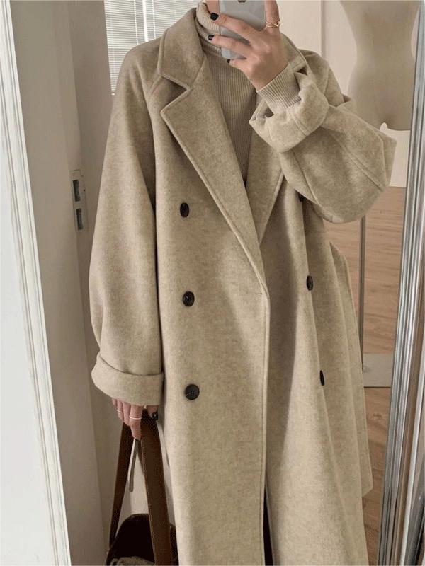 Stylish woman wearing a classic belted long winter coat, showcasing its elegant fit and modern winter fashion appeal.