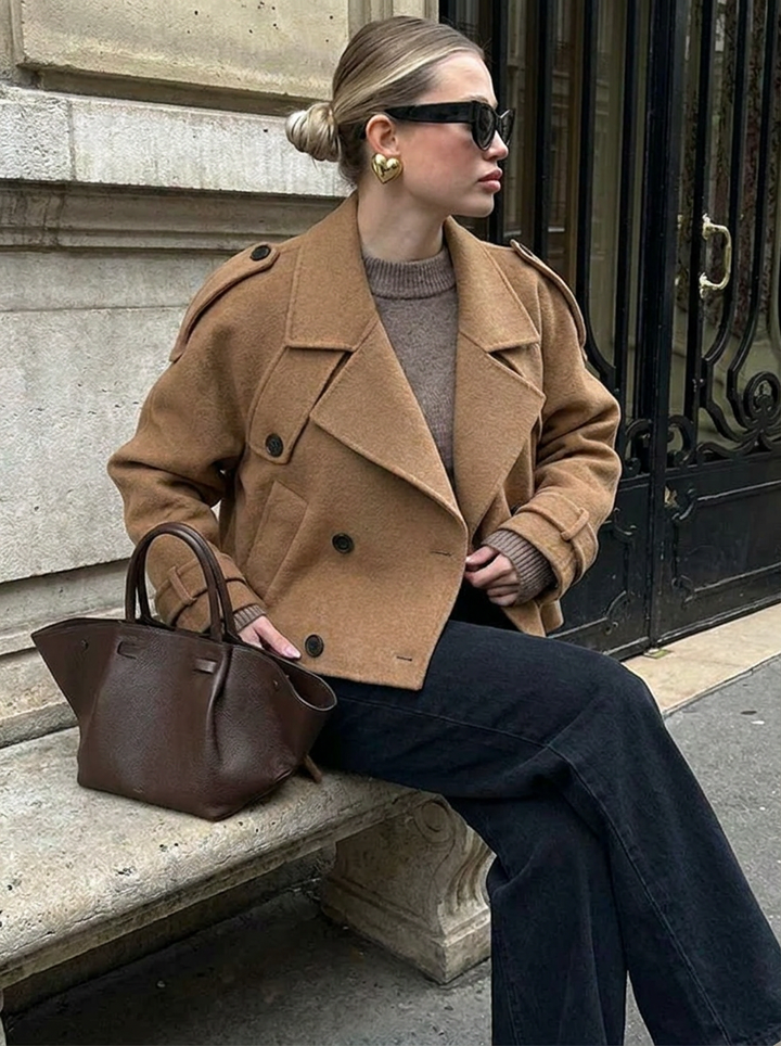 Classic women's cropped trench coat in brown, double-breasted for effortless style. Versatile fall/winter outerwear jacket.