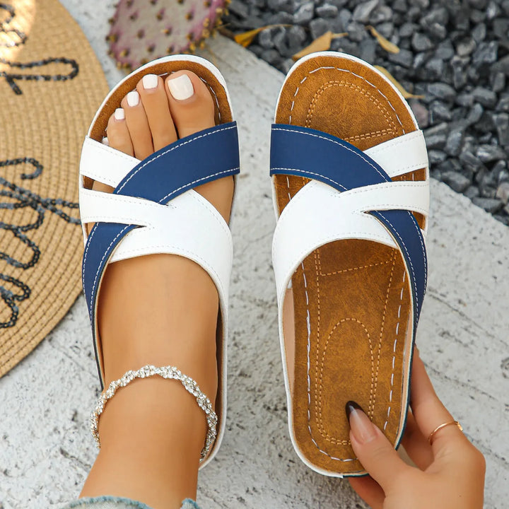Versatile women's low heel sandals with classic cross straps & open toe, ideal for casual or dressy outfits.