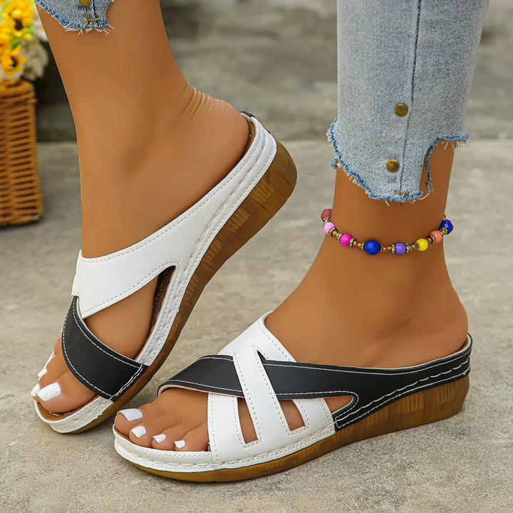 Stylish women's low heel sandals with elegant cross straps, providing comfort & a classic look for spring/summer.