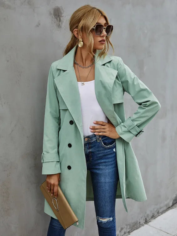 Elegant women's mid-length trench coat, double-breasted design with a stylish belted waist for seasonal wear.