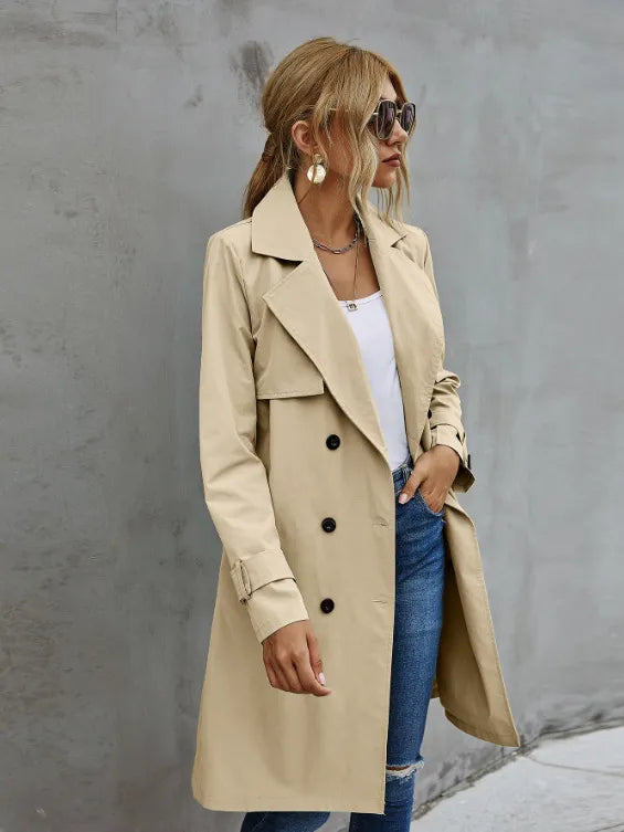Stylish women's classic trench coat, featuring a double-breasted front and an adjustable belted waist for outerwear.