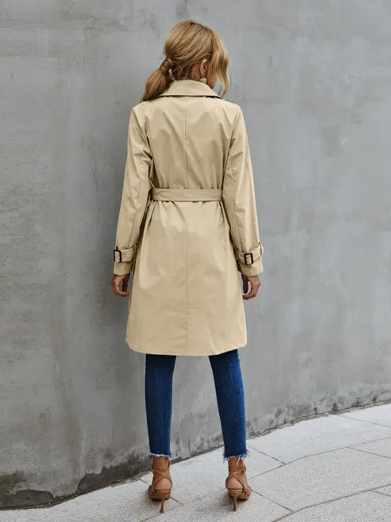 Versatile women's double-breasted trench coat, a classic mid-length design with a flattering belted waist.