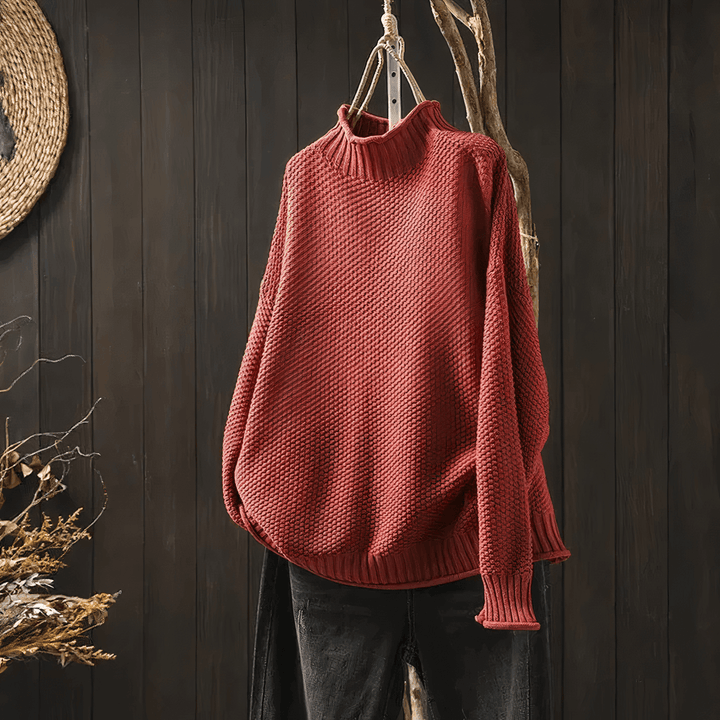 Close-up of a women's soft knit turtleneck sweater, showcasing the classic design and comfortable, warm fabric.