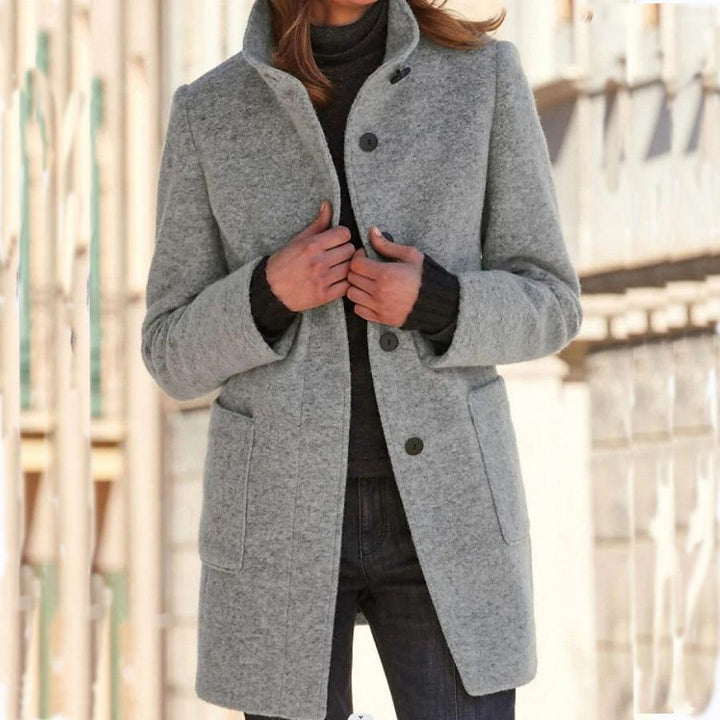 Elegant long women's wool coat with retro buttons. Perfect classic trench for fall & winter fashion.