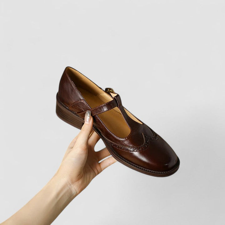 Woman wearing stylish beige Mary Jane flats, perfect for a casual day out.