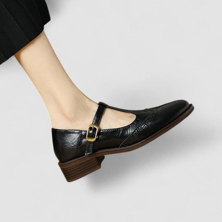 Close-up of beige Mary Jane flats, highlighting comfortable material & classic design.