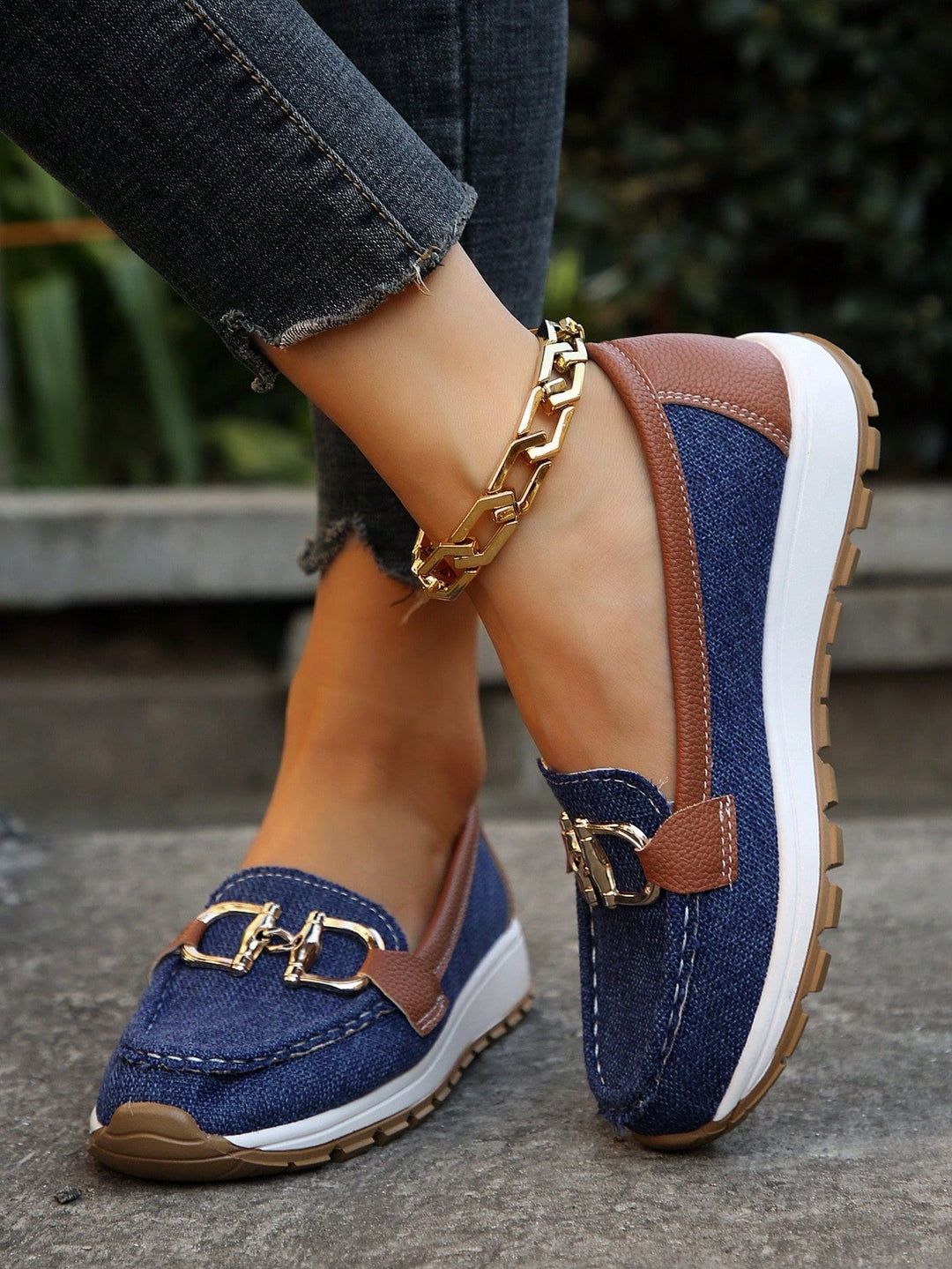 Blue women's casual loafers with decorative buckle and non-skid sole, top view