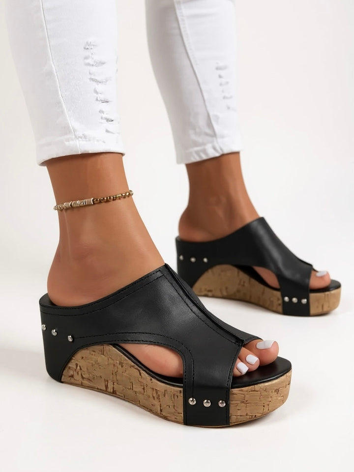 Chic white slip-on wedge sandals for women, perfect for warm weather comfort and fashion.