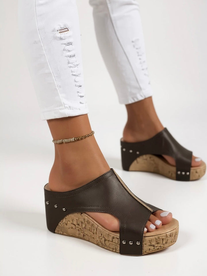 Fashionable women's wedge slide sandals, offering comfortable slip-on style for summer outings.