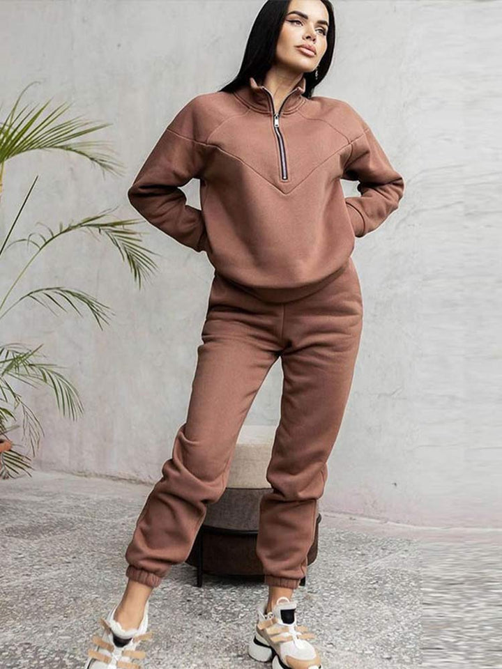 Women's comfortable casual tracksuit set with zip neck top and tapered trousers, perfect for loungewear & everyday style.