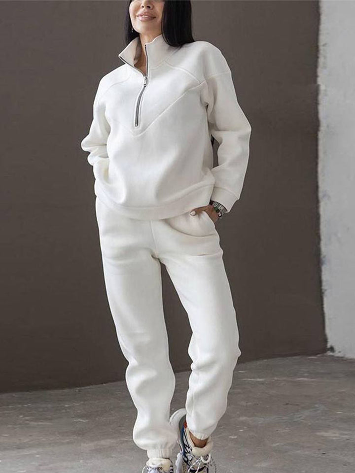 Versatile women's athleisure tracksuit, including a chic zip neck top & modern tapered trousers for comfort.