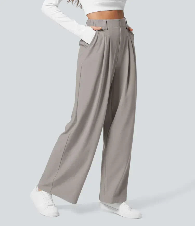 Flat lay of women's comfortable stretch trousers, highlighting modern design & soft fabric for flexible fashion.