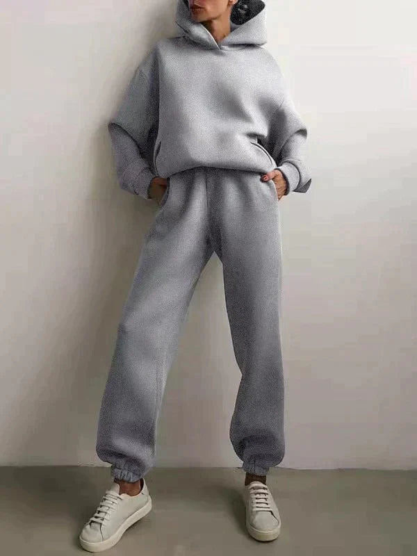 Women's comfortable hoodie and jogging pants set. Versatile two-piece activewear for any activity.