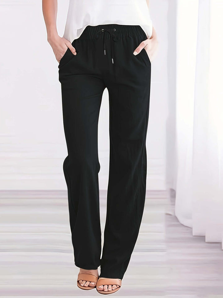Women's comfortable wide-leg drawstring trousers with adjustable waist and practical side pockets, ideal for casual wear.