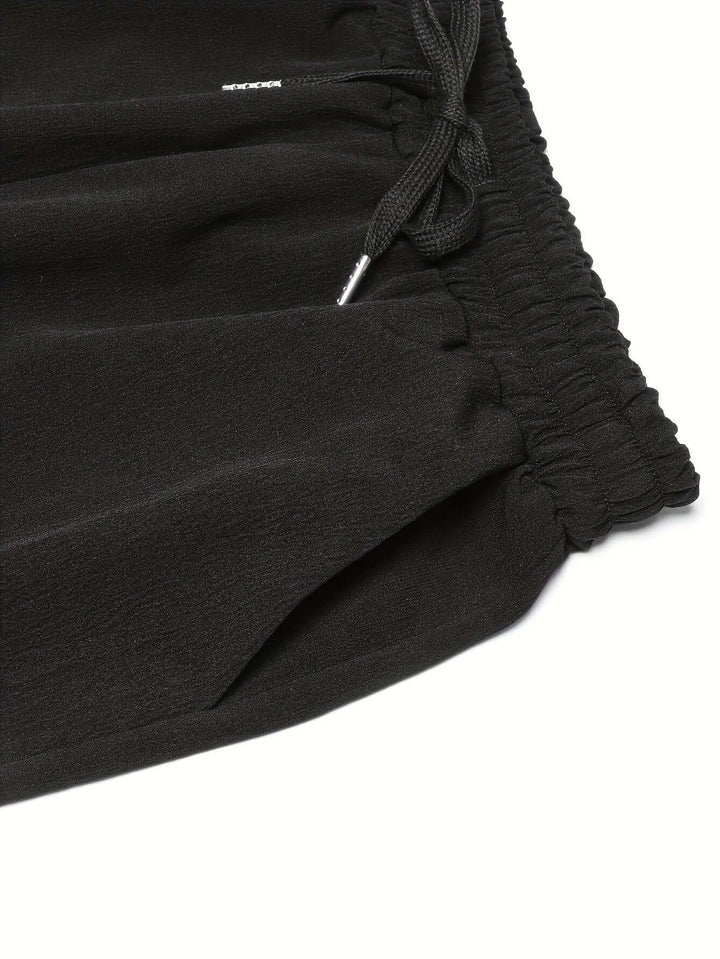 Soft women's wide-leg trousers with an elastic drawstring waist and deep pockets, designed for ultimate comfort and style.