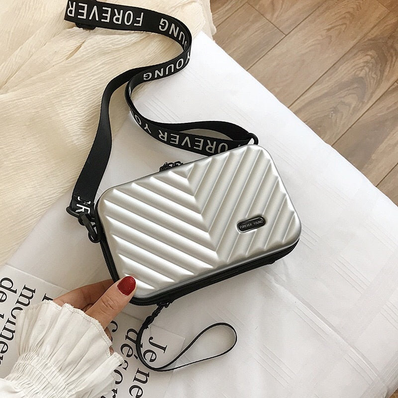 Secure women's compact hard shell crossbody bag. Durable travel handbag, ideal for essentials.