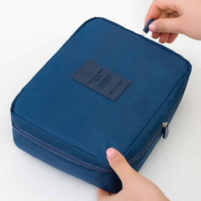 Front view of women's compact waterproof makeup travel organizer in a vibrant floral print.