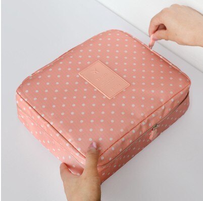 Close-up of waterproof fabric on a women's compact makeup travel organizer, durable design.