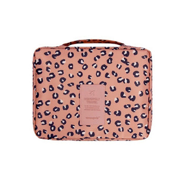 Interior view of women's compact waterproof cosmetic travel organizer with brushes & makeup.
