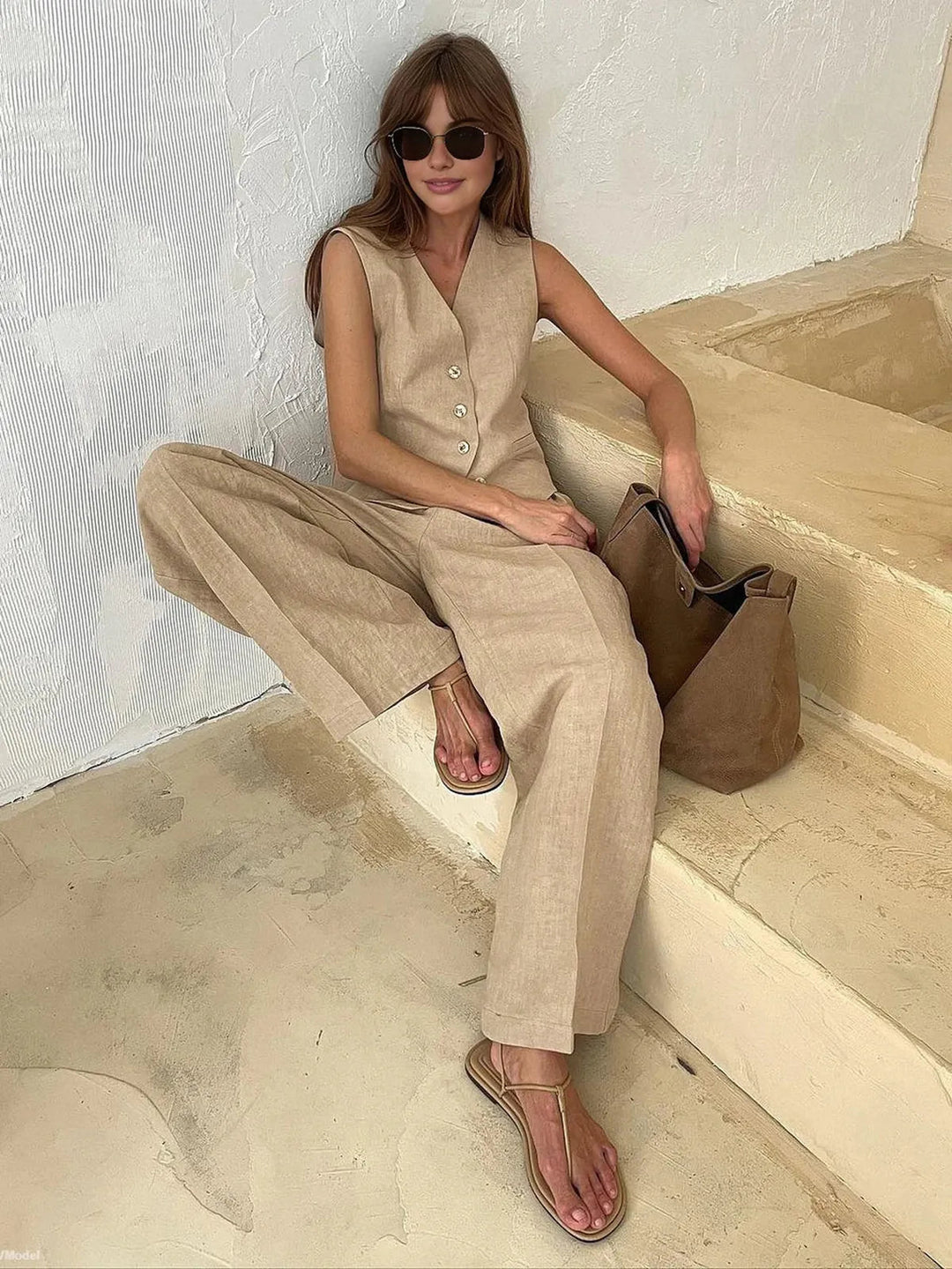Fashionable women's two-piece cotton linen set featuring a relaxed fit waistcoat & wide-leg pants for summer fun.