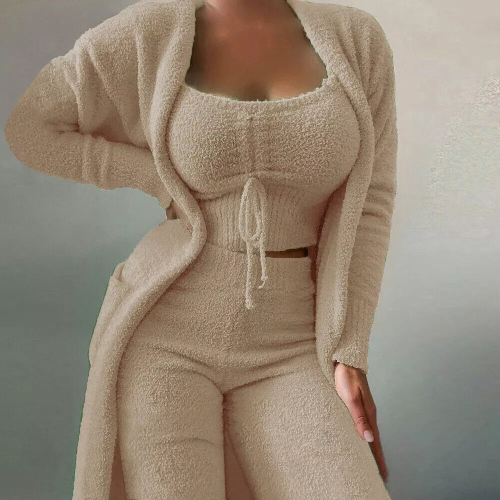 Woman relaxing in a comfortable 3-piece women's lounge set, featuring a matching top, pants, and cardigan.