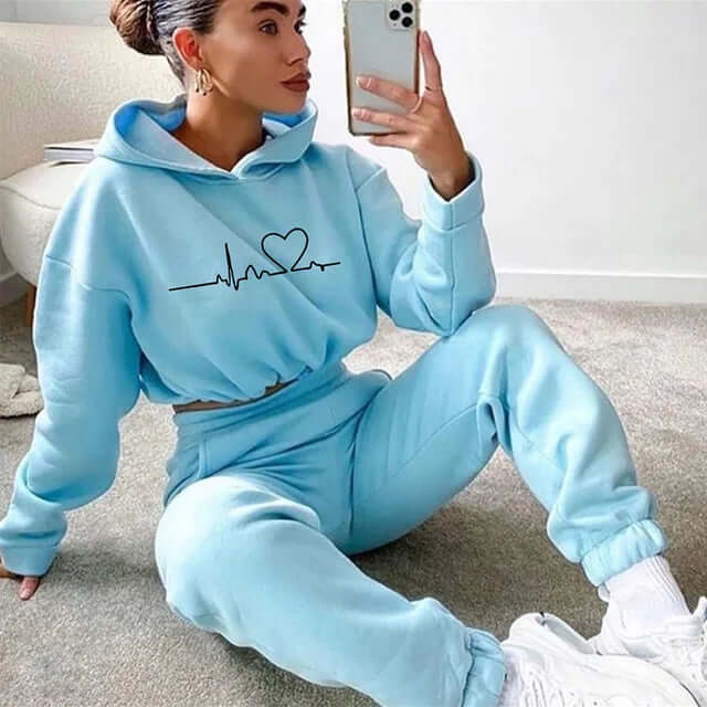 Athletic women's sports set with a comfortable hoodie and supportive leggings for workouts or jogging.