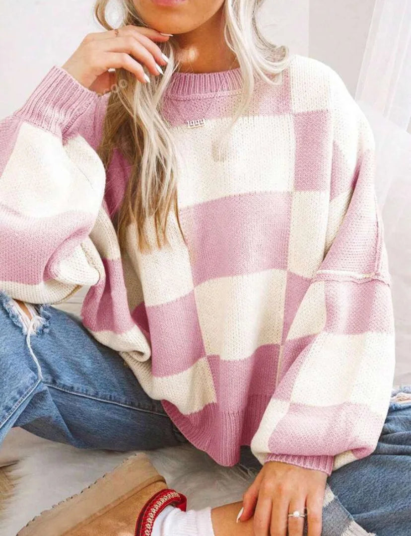 Soft women's checkerboard sweater. Stylish oversized design for winter comfort.
