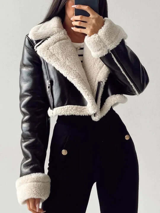 Detail shot of a women's cozy fleece-lined short jacket, highlighting soft fabric texture and warmth.